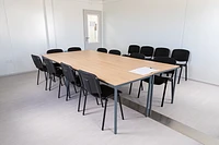 Modular building meeting room with large table and chairs, two bays wide