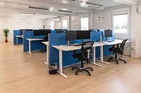 Modular building open plan office space, with desks, chairs, computers, and desk dividers