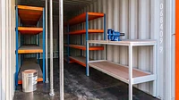 20ft shipping container workshop with racking and work bench