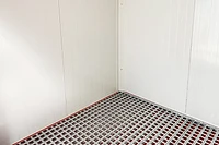 Flat Pack insulated chemical store interior with bund flooring, off-white and red finish