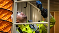 Confined space training unit container interior with man at ladder