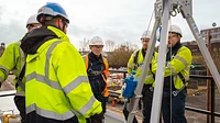 Confined space training unit container with personnel on the roof platform