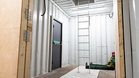 Confined space training unit container interior with roof access ladder
