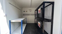 Bespoke container workshop with work bench and chemical storage cage inside