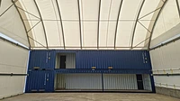 Bespoke container conversions with open sides, stacked under a Zappshelter canopy