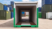 Tunnel container in green and white with large roller shutters open at each end