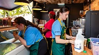 Container ice cream kiosk interior with staff at counters