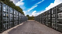 Two rows of 20ft containers facing one another on a self storage site