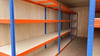Shipping container interior with racking and ply lining