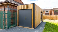Container with storage and rollershutter