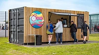 Converted refreshments kiosk with cladding and serving hatch
