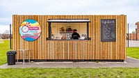 Converted refreshments kiosk with cladding and serving hatch