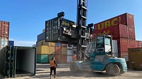 Two One Trip Green Tri Door Shipping Containers Being Delivered 