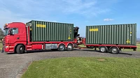 Two One Trip Green Tri Door Shipping Containers Being Delivered 