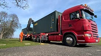 Two One Trip Green Tri Door Shipping Containers Being Delivered 