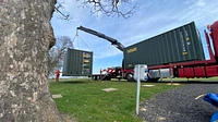 Two One Trip Green Tri Door Shipping Containers Being Delivered 