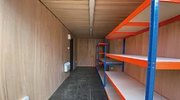Interior of workshop container conversion with racking