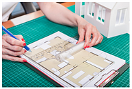 Woman drawing up a floorplan design for planning permission application.
