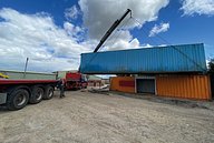 A shipping container being lifted