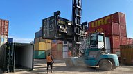 Two One Trip Green Tri Door Shipping Containers Being Delivered 