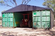Container shed housing a tractor 