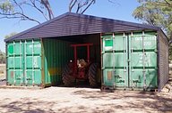 Container shed housing a tractor