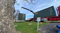 Two One Trip Green Tri Door Shipping Containers Being Delivered 