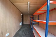 Interior of workshop container conversion with racking
